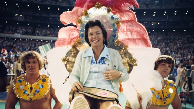 Billie Jean King, in a green and blue dress that included sequins and rhinestones, was brought to the court like Cleopatra on an Egyptian litter, adorned with red and orange feathers.